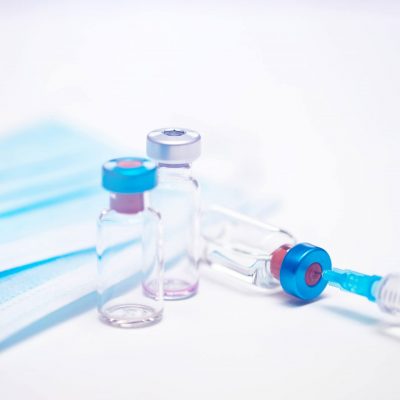close-up-on-vaccine-and-medical-syringe-FUMLKTS-e1606469474872.jpg